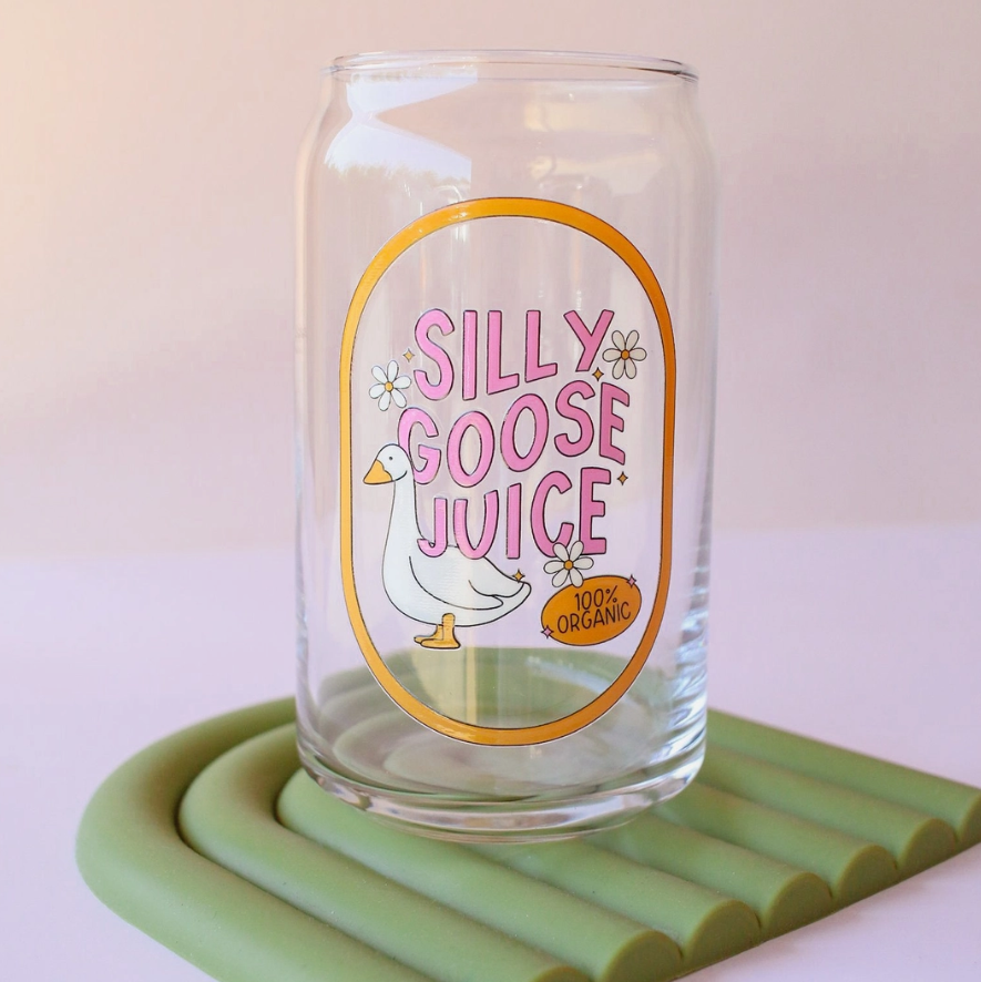 Clear glass with 'Silly Goose Juice' label on a green coaster