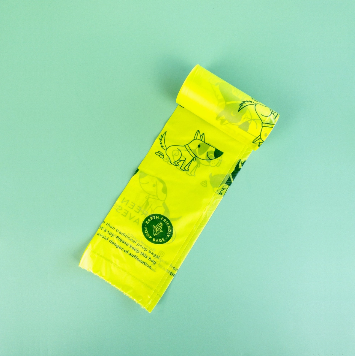 Yellow dog waste bag on a light green background