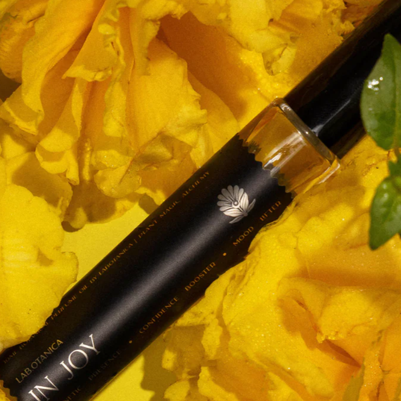 Perfume In Joy with visible branding on yellow flowers
