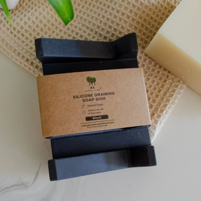 Silicone draining soap dish with a cardboard label on a textured surface