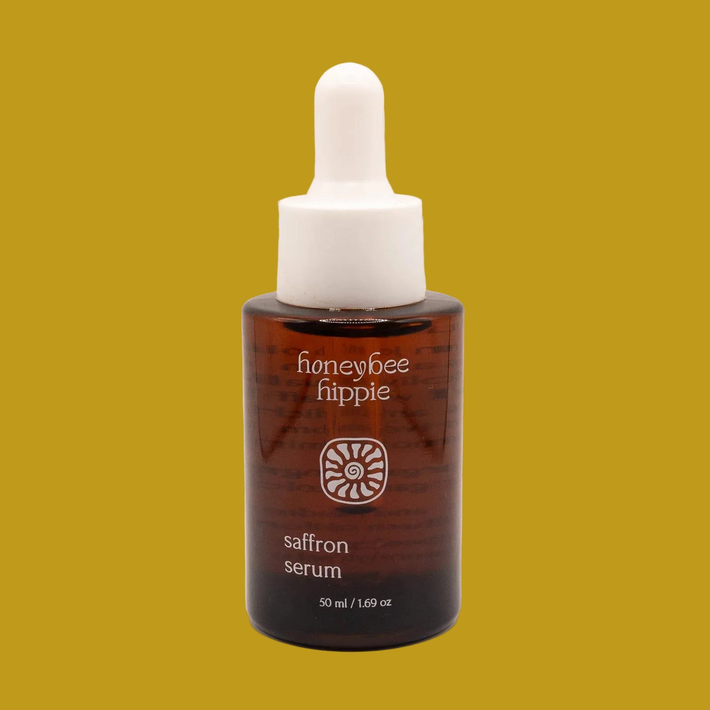 Honeybee Hippie saffron serum bottle on a beige background