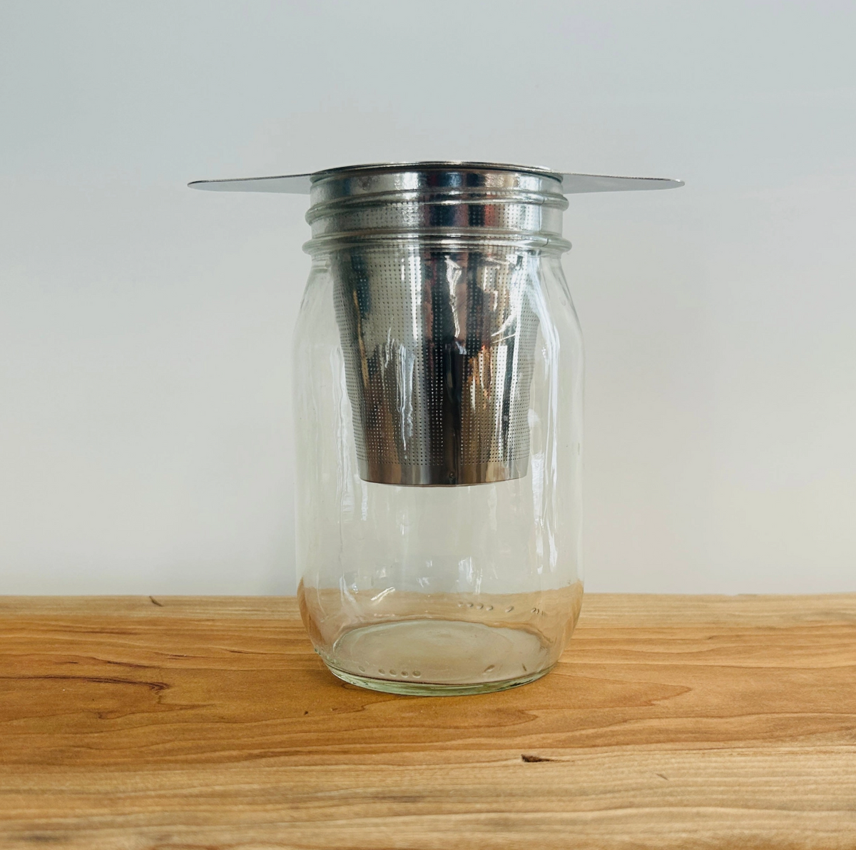 STAINLESS STEEL TEA STEEPER STRAINER SITS ON MUG