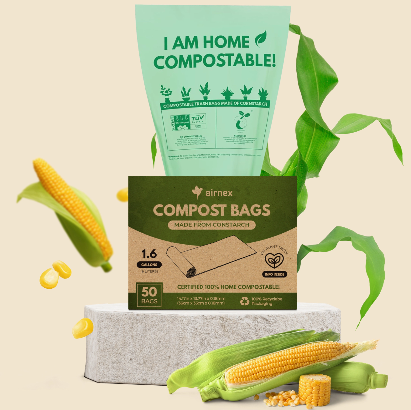 A box of Airmex compost bags sits on a light gray pedestal with a large mint-green compost bag floating behind it. The scene includes corn cobs, green leaves, and loose corn kernels on a warm beige background.