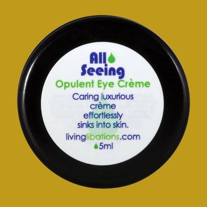 A black pot with a white label that reads 'All Seeing Opulent Eye Crème', with blue and green text detailing the product's benefits and the brand's website.