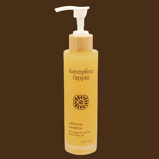 Yellow bottle of honeybee hippie California Sunshine body oil on a beige background