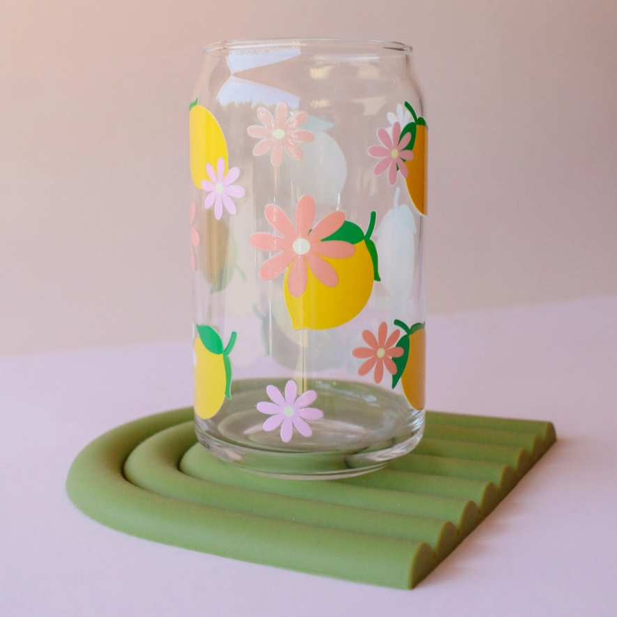 Clear glass with lemon and flower design on a green coaster