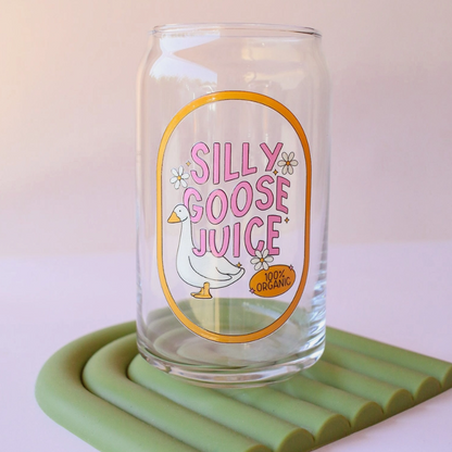 Clear glass with 'Silly Goose Juice' label on a green coaster