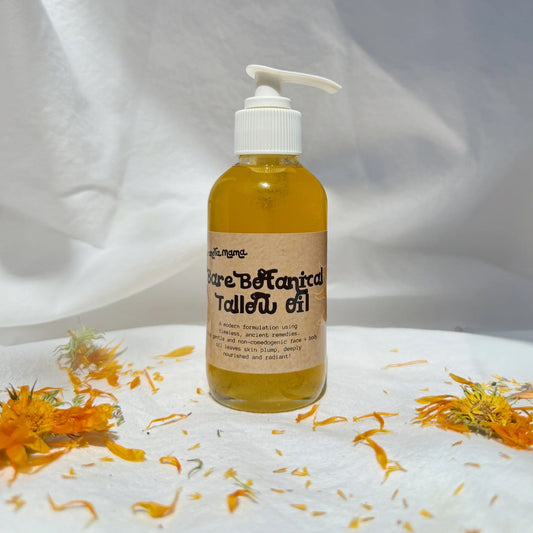 Bottle of tallow oil with pump on a white background with marigold flowers.
