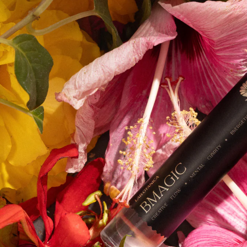 Floral arrangement with a perfume bmagic on top