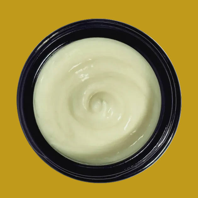 Black container with greenish cream on a white background