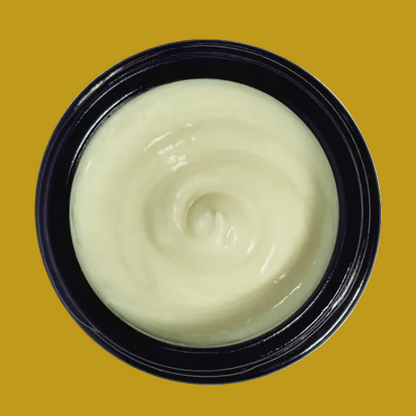 Black container with greenish cream on a white background