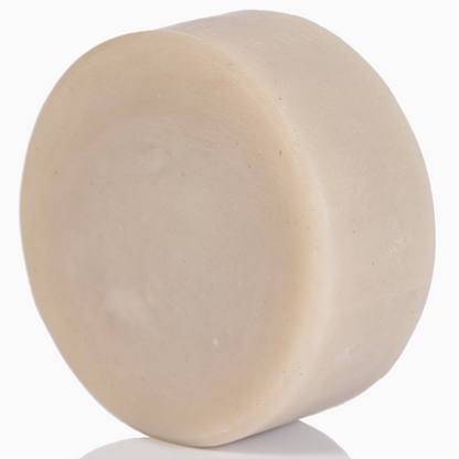 Beige bar of soap on a white background