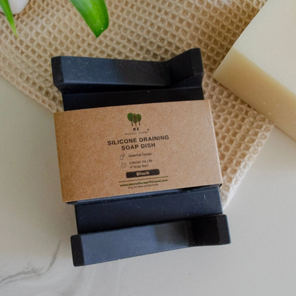 Silicone draining soap dish with a cardboard label on a textured surface