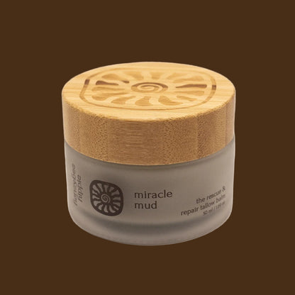 Jar of 'miracle mud' with a wooden lid on a white background