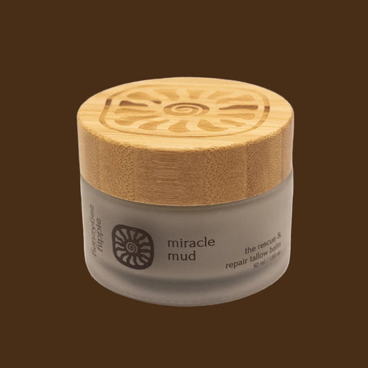 Jar of 'miracle mud' with a wooden lid on a white background