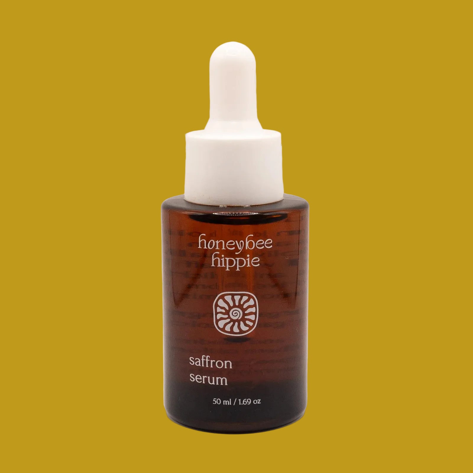 Honeybee Hippie saffron serum bottle on a beige background