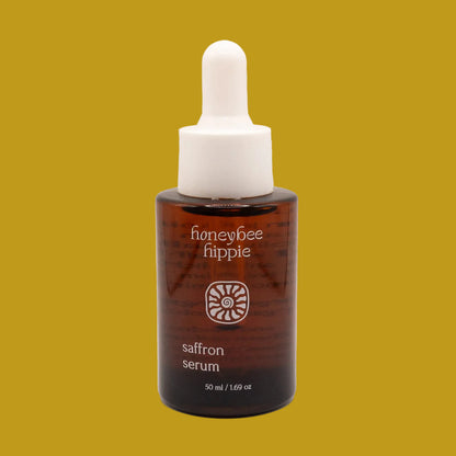 Honeybee Hippie saffron serum bottle on a beige background