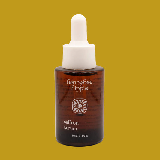Honeybee Hippie saffron serum bottle on a beige background