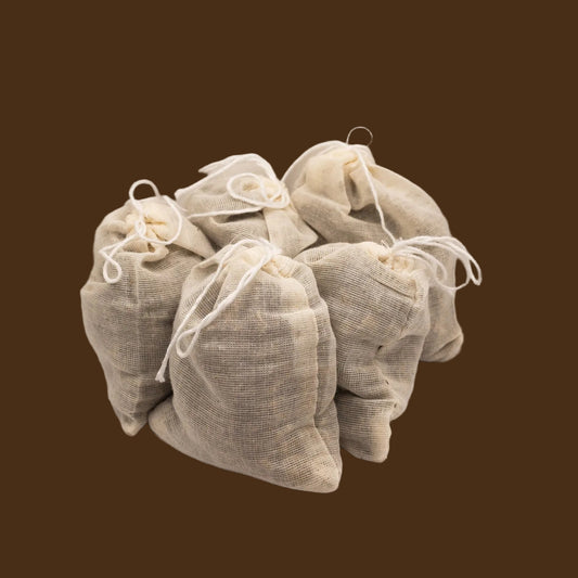 Five beige fabric bags with drawstrings on a light beige background
