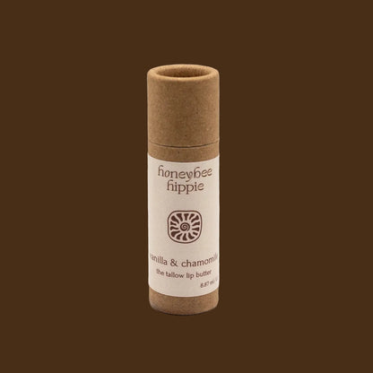 Lip balm tube with 'honeybee hippie' branding on a beige background