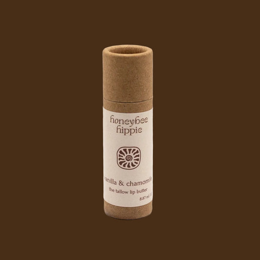 Lip balm tube with 'honeybee hippie' branding on a beige background