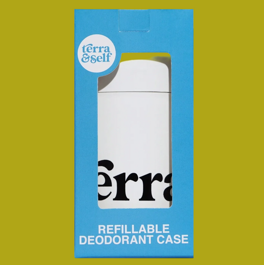 A white refillable deodorant case by Terra & Self, shown inside its bright blue retail packaging box with a die-cut window.