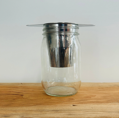 STAINLESS STEEL TEA STEEPER STRAINER SITS ON MUG