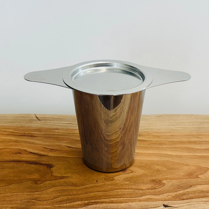 STAINLESS STEEL TEA STEEPER STRAINER SITS ON MUG